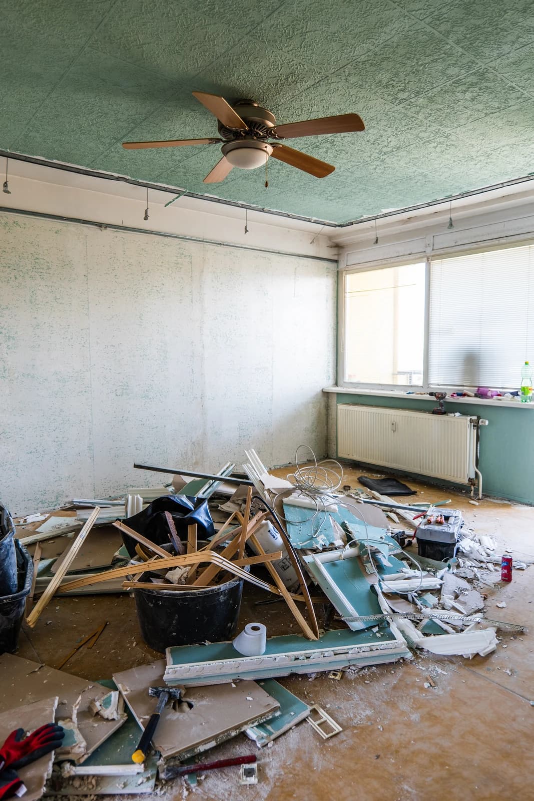 Štýlová tmavá kuchyňa s moderným osvetlením, zlatými akcentmi a elegantným jedálenským stolom.