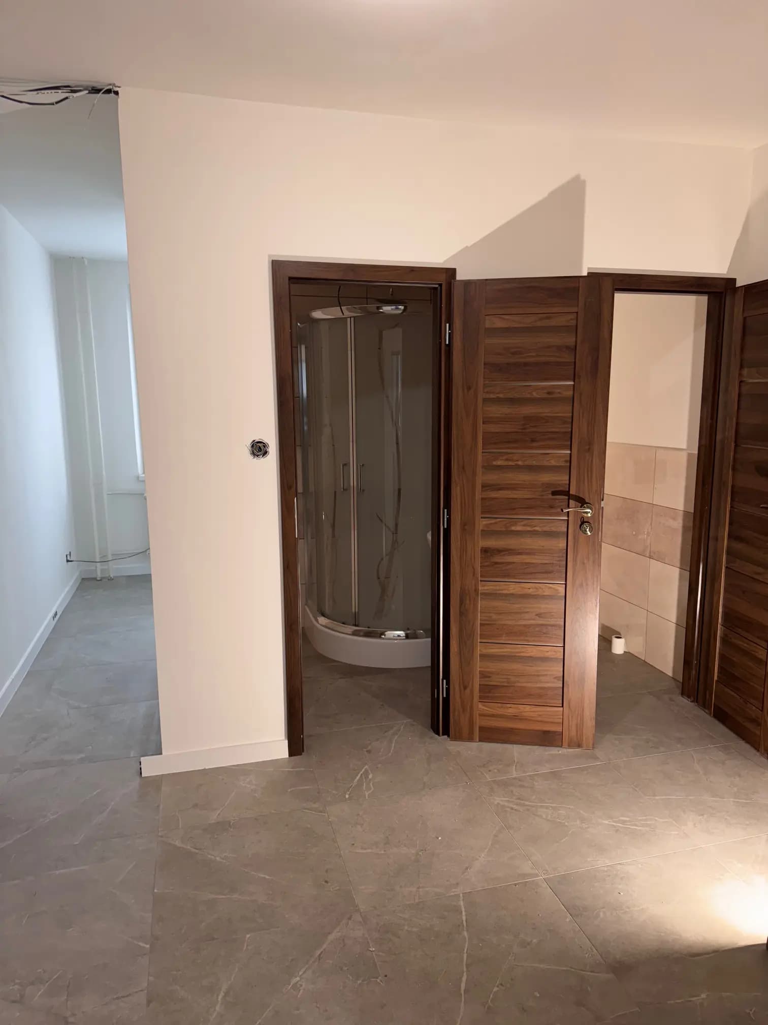 Moderná kancelária v minimalistickom štýle s elegantnými pracovnými stolmi a prírodnými materiálmi.